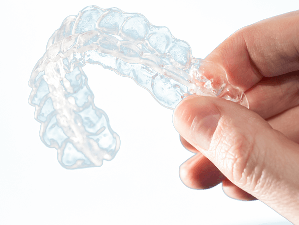 hand holding upper and lower invisalign aligners